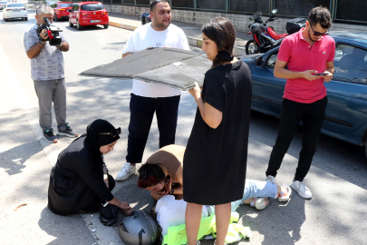 Yaralı motosikletliyi sağlık ekibi gelene kadar bagaj halısıyla güneşten korudular